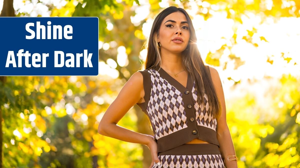A caucasian brunette woman in autumn at sunset in a natural city park.